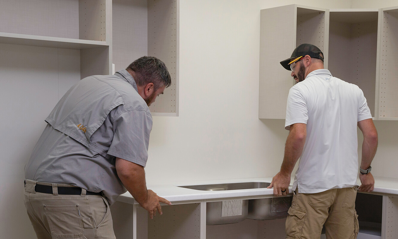 Two Men Installing A Countertop