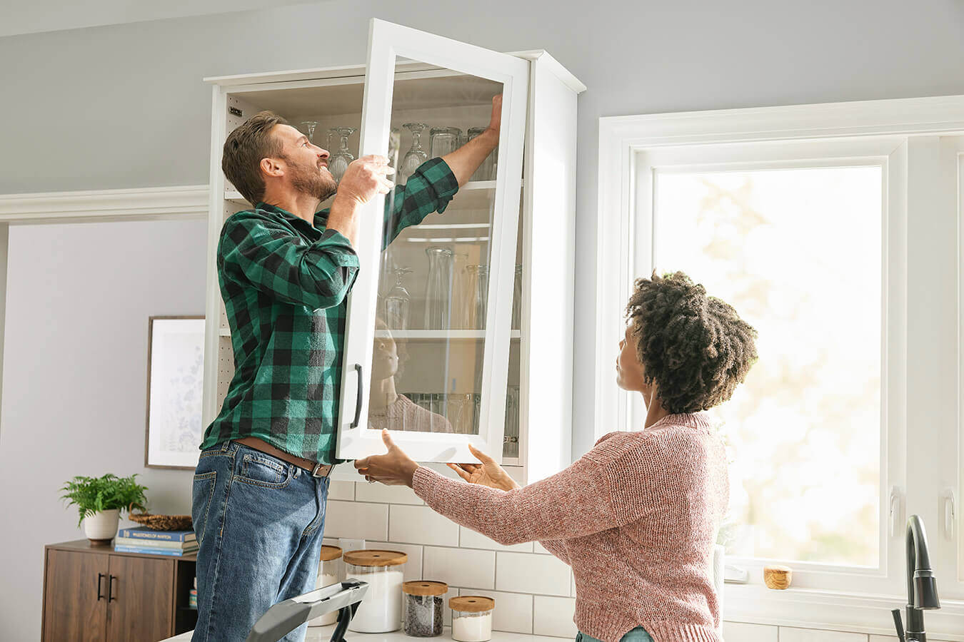 Couple Putting In A Glass Door Front